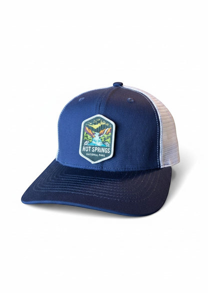 Moove Headwear navy blue trucker hat with white mesh back and Hot Springs National Park patch