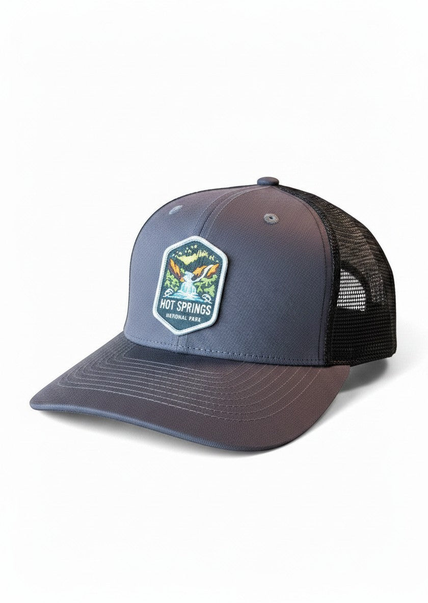 Moove Headwear grey trucker hat with black mesh back and Hot Springs National Park patch. Adjustable snapback closure.