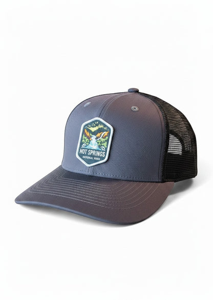 Moove Headwear grey trucker hat with black mesh back and Hot Springs National Park patch. Adjustable snapback closure.