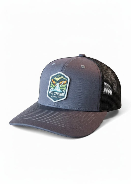 Moove Headwear grey trucker hat with black mesh back and Hot Springs National Park patch. Adjustable snapback closure.