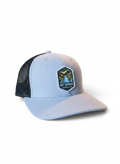 Moove Headwear light blue trucker hat with black mesh back and Hot Springs National Park patch.