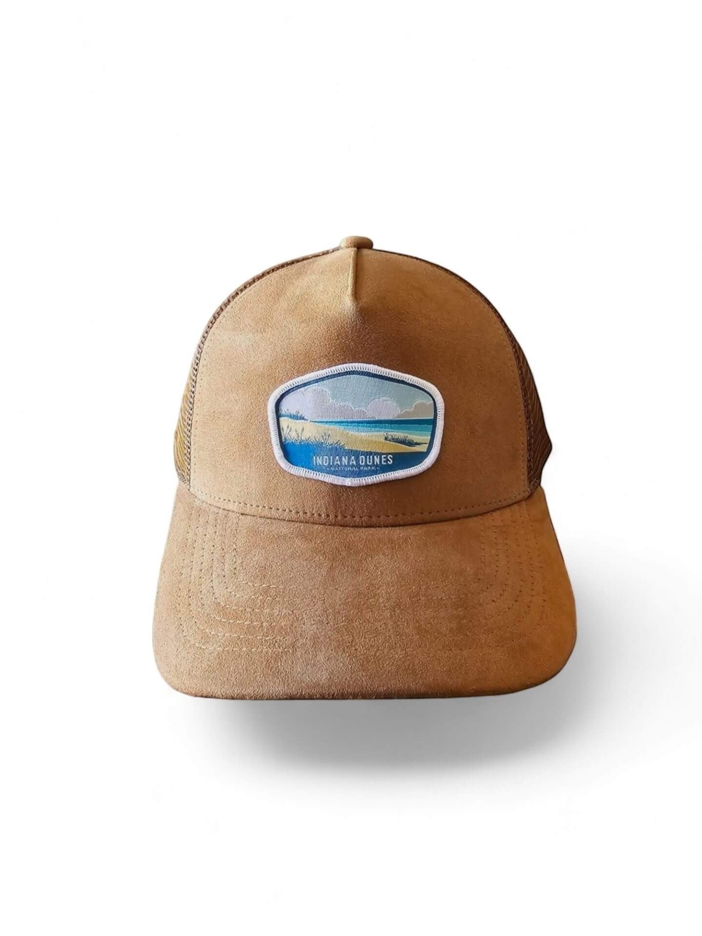 Moove Headwear tan suede trucker hat with mesh back and Indiana Dunes patch. Adjustable snap closure.