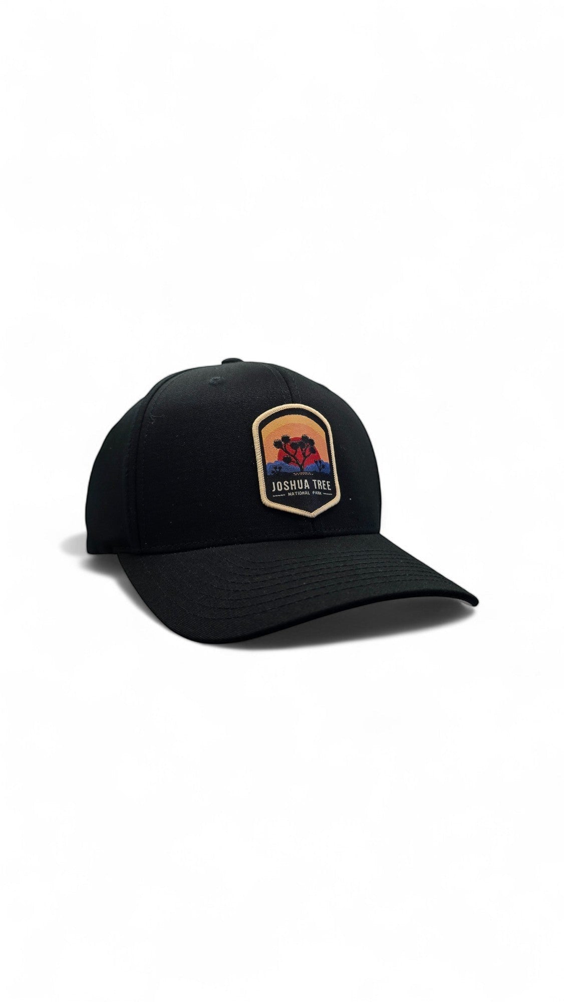 Moove Headwear black Flexfit cap with a Joshua Tree National Park patch featuring a sunset and silhouette of trees.