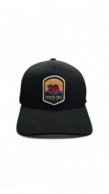 Moove Headwear black Flexfit cap with embroidered Joshua Tree National Park sunset patch. Hiking gear.