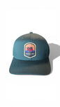 Moove Headwear dark teal Flexfit cap with Joshua Tree National Park embroidered patch. Designed for hiking and outdoor adventures.