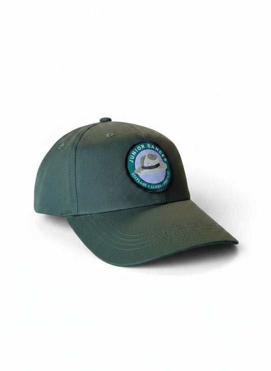Moove Headwear Junior Park Ranger hat for kids, dark green fabric with a circular patch featuring a ranger hat and "Explore Learn Protect" text.