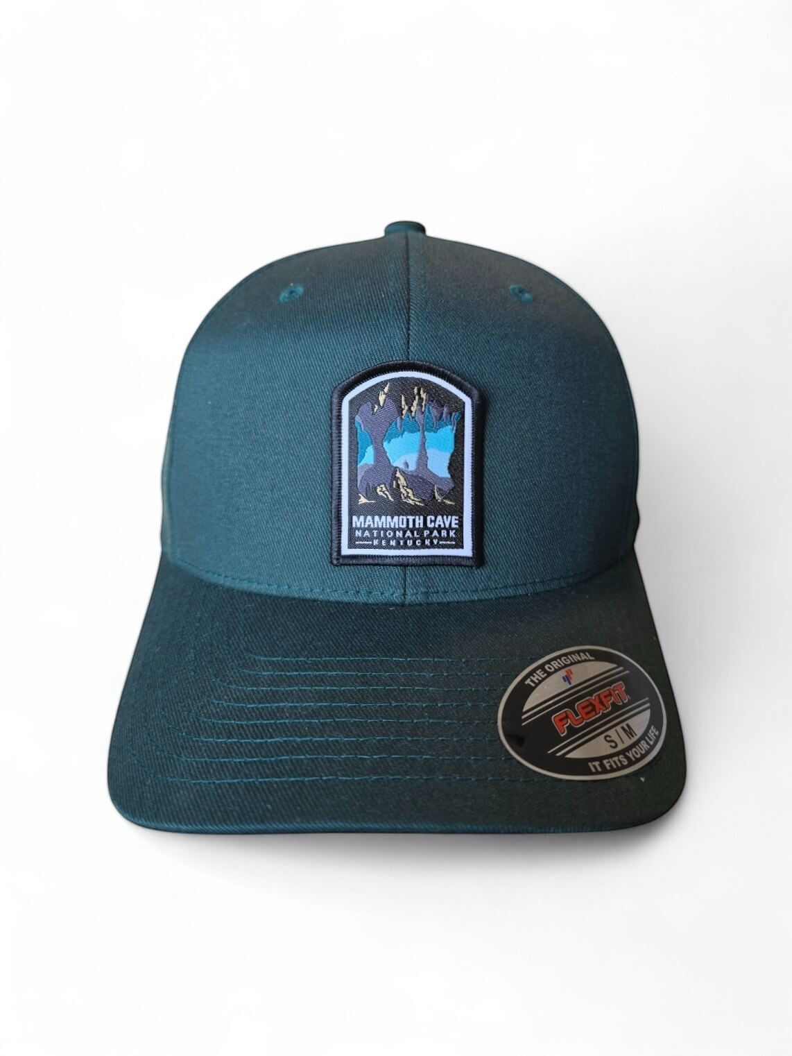 Moove Headwear dark teal embroidered hat featuring a woven patch of Mammoth Cave National Park with stalactites and stalagmites.