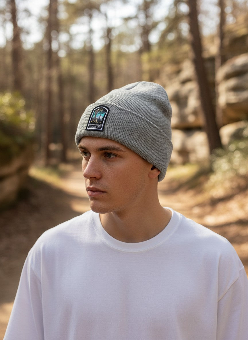 Moove Headwear grey rib-knit beanie with a Mammoth Cave National Park patch worn by a man in a forest setting.