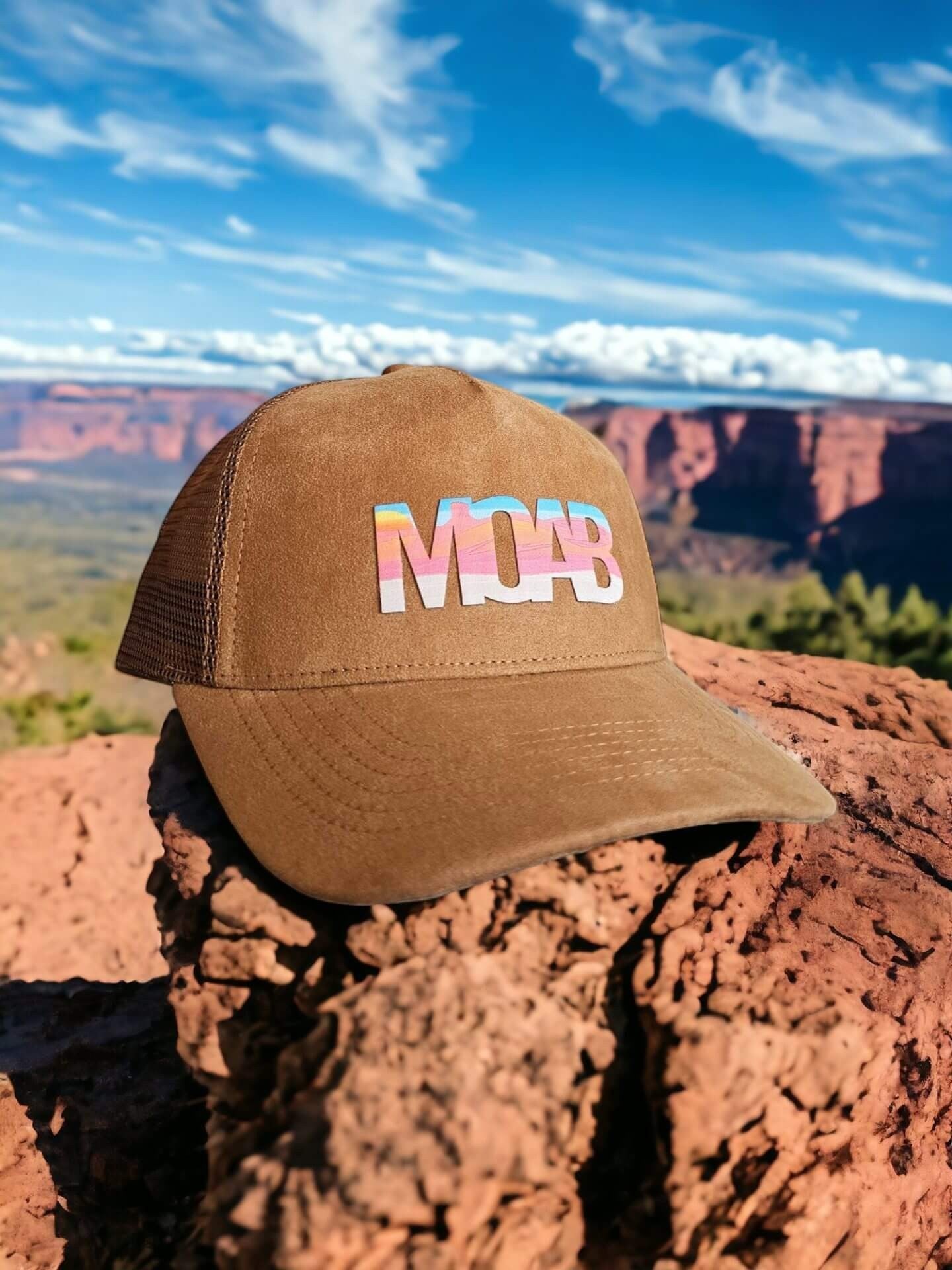 Moove Headwear brown suede trucker hat with colorful "MOAB" graphic, mesh back, and adjustable fit. Perfect for hiking.
