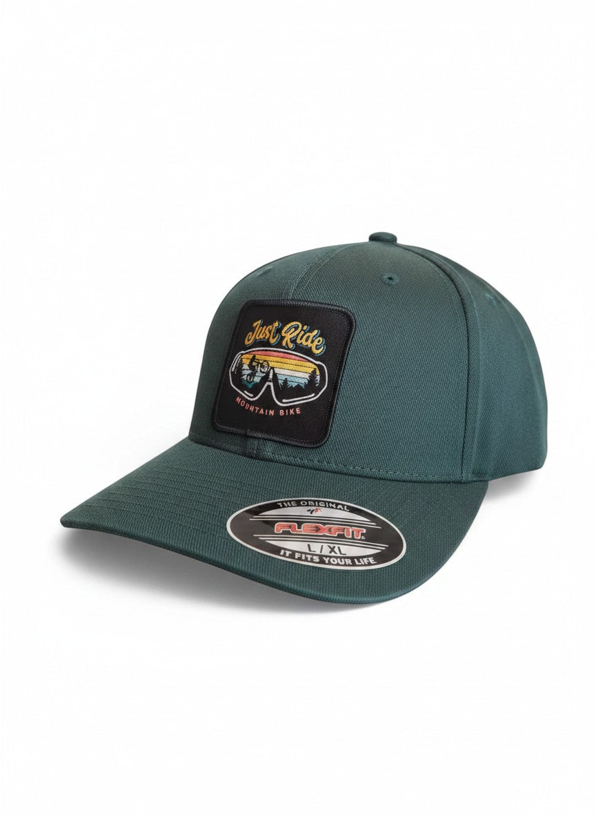 Moove Headwear dark green fitted baseball cap with "Just Ride Mountain Bike" patch featuring a cyclist and sunset.