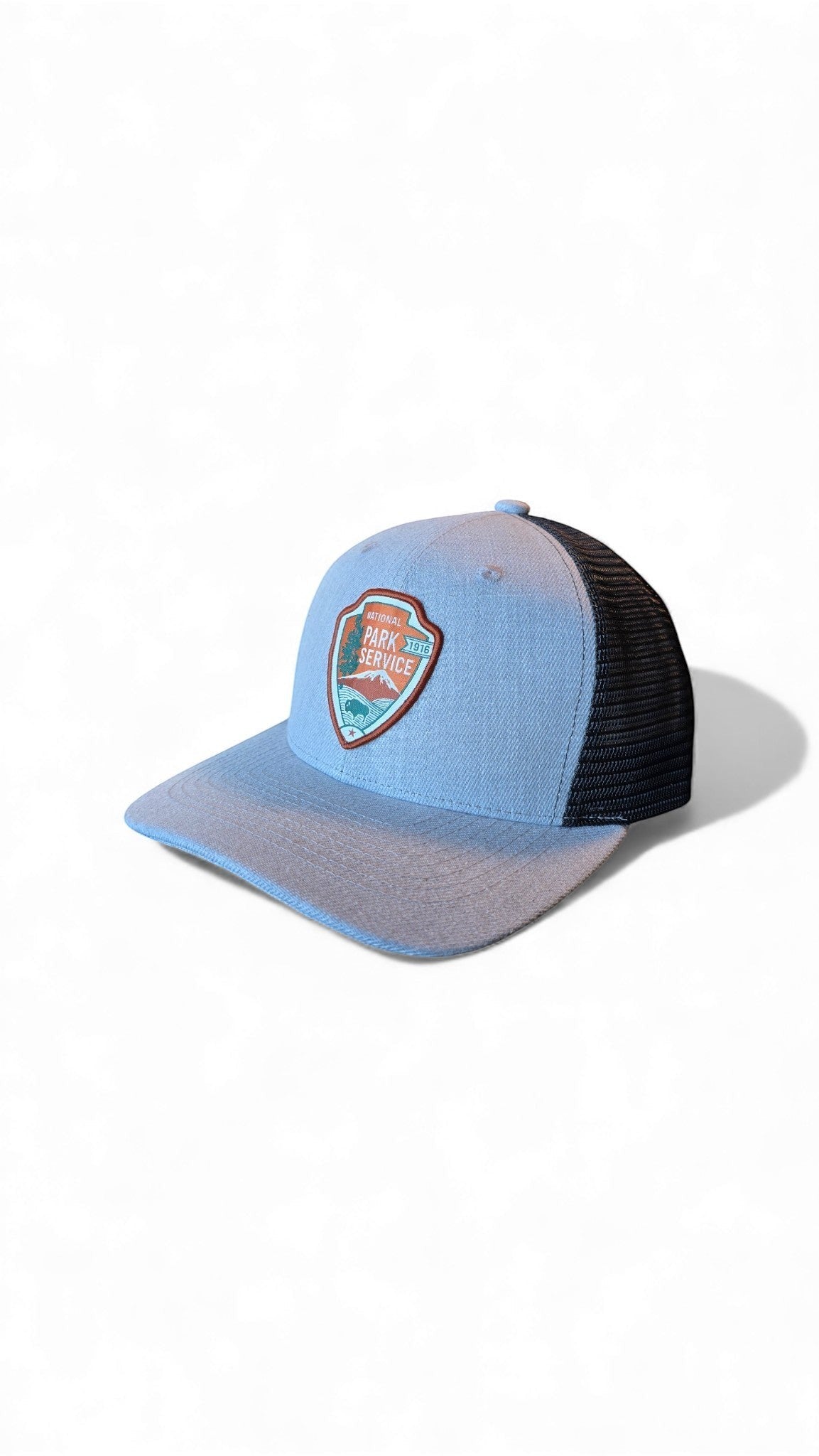 Moove Headwear light blue trucker hat with black mesh back and National Park Service badge