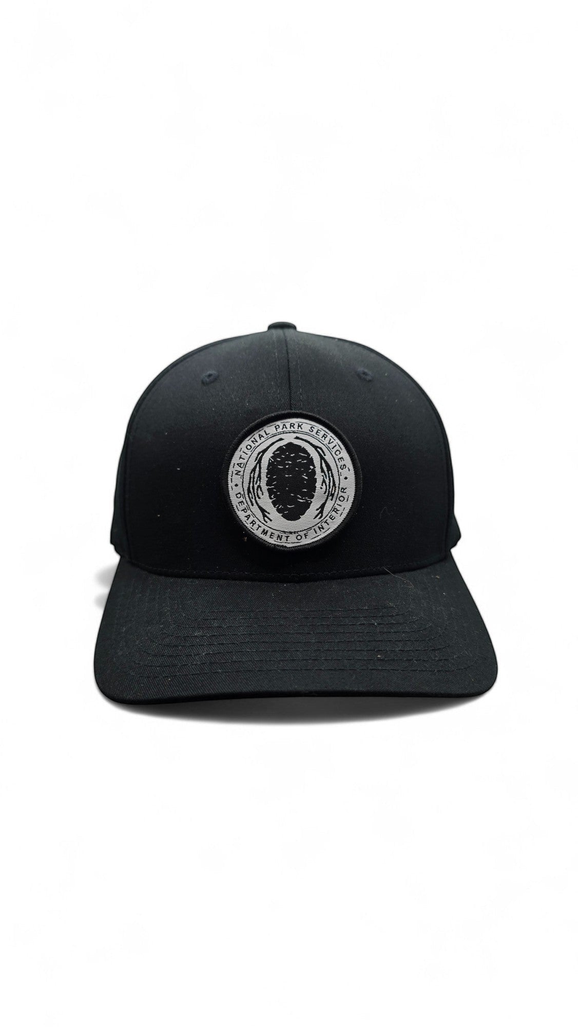 Moove Headwear black Flexfit hat with embroidered National Park Service logo patch on the front.