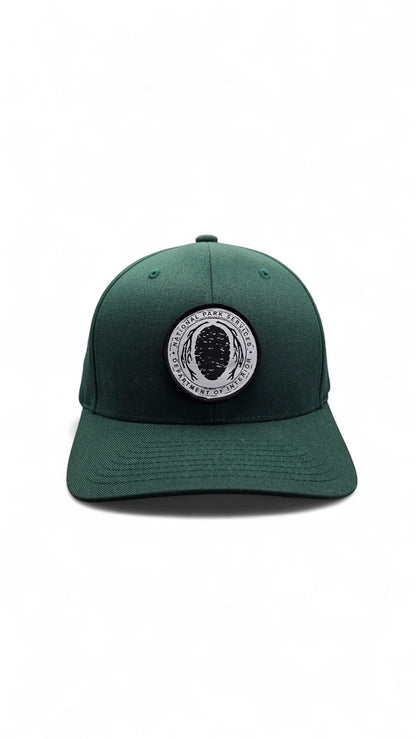 Moove Headwear dark green Flexfit hat with embroidered National Park Service logo patch on the front.