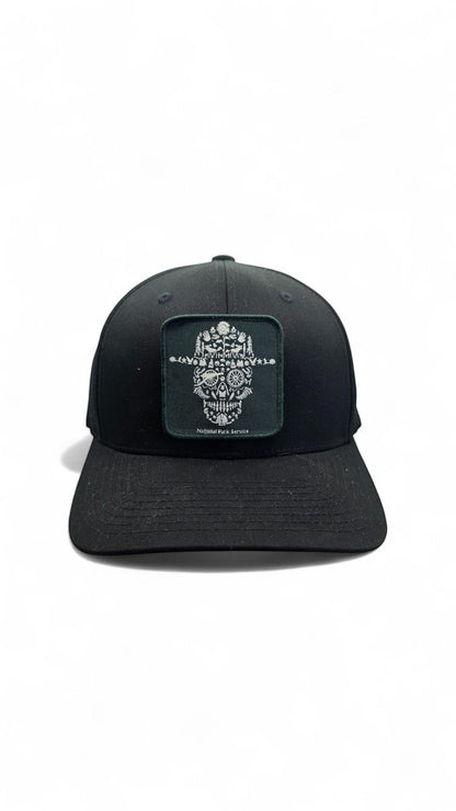 Moove Headwear black fitted National Park Service ranger hat with a square patch featuring a skull design made of nature elements.