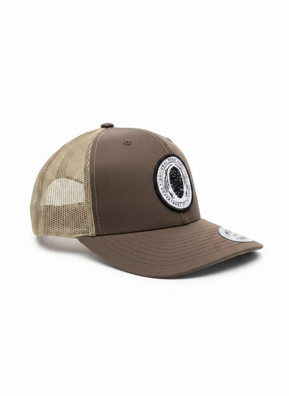 Moove Headwear brown trucker hat with National Park Service Sequoia Cone patch and tan mesh back. Adjustable snapback.