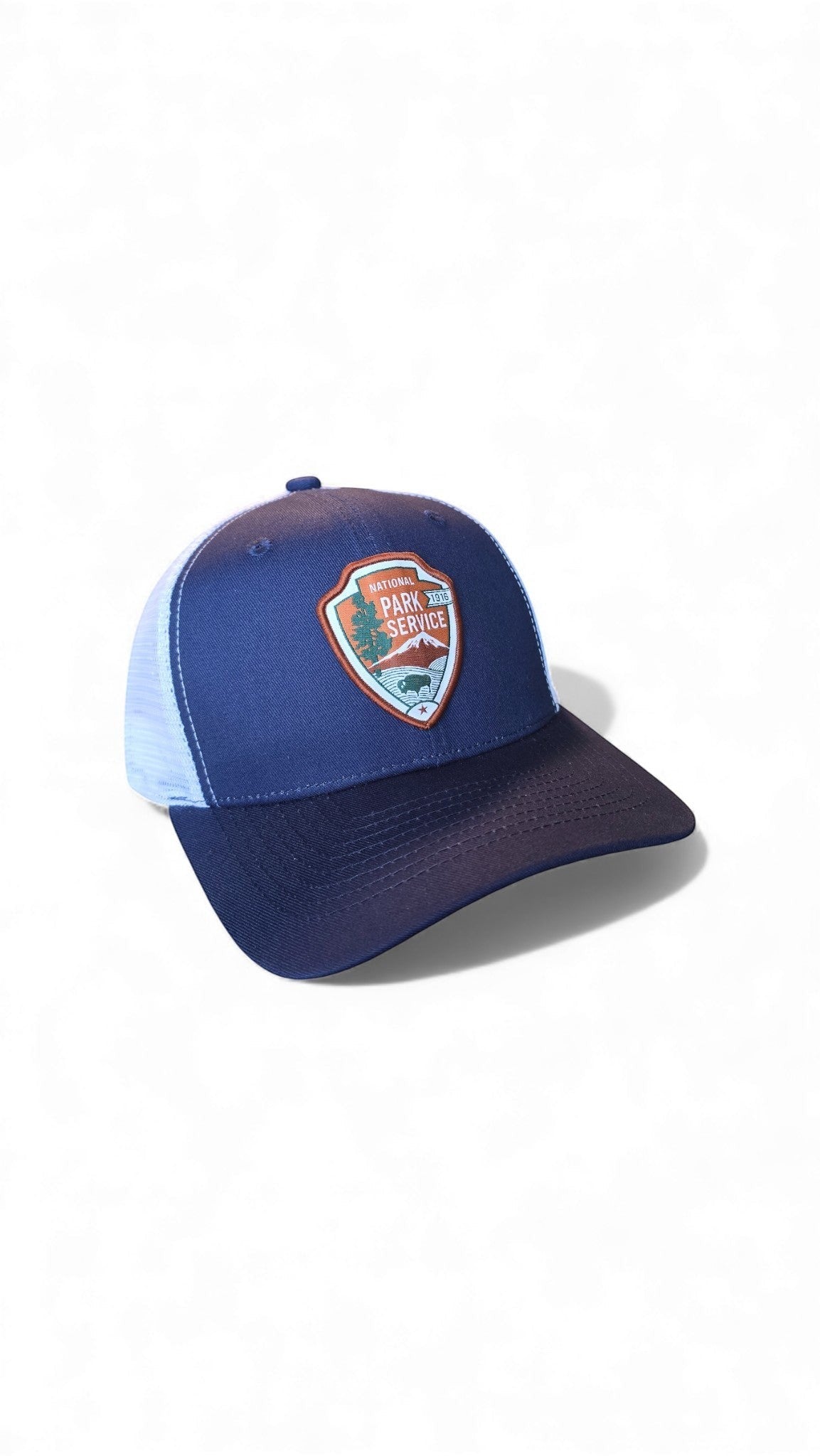 Moove Headwear navy blue trucker hat with National Park Service patch and white mesh back. Adjustable snapback closure.