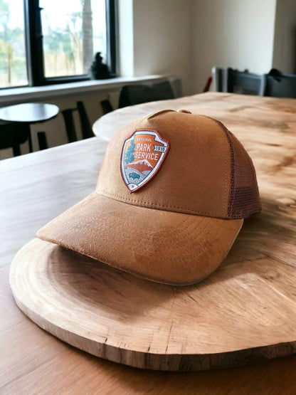 Moove Headwear National Park Service suede snapback hat with embroidered NPS emblem and mesh back panels.