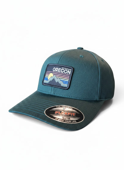 Moove Headwear dark teal baseball cap with embroidered Oregon mountain and sun patch, Flexfit technology.