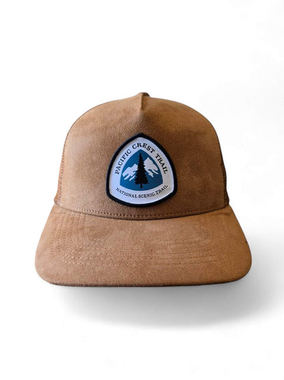 Moove Headwear brown suede trucker hat with mesh back and Pacific Crest Trail patch. Adjustable snapback for a secure fit.