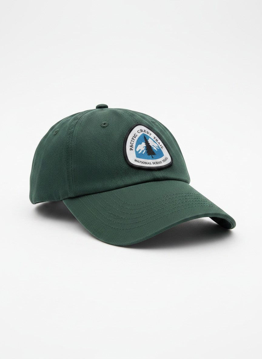 Moove Headwear dark green cotton baseball cap with embroidered Pacific Crest Trail logo patch and adjustable strap.