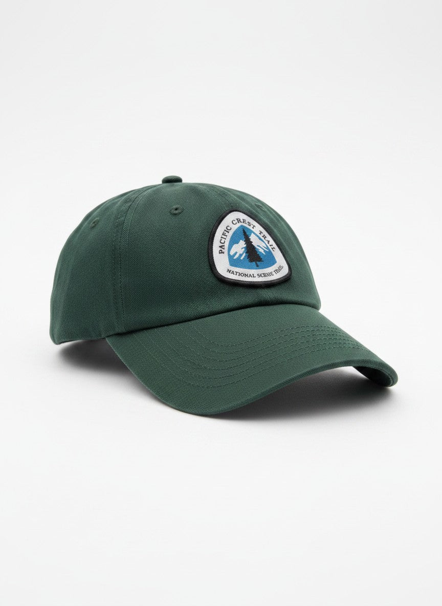 Moove Headwear dark green cotton baseball cap with embroidered Pacific Crest Trail logo patch, adjustable strap for hiking.