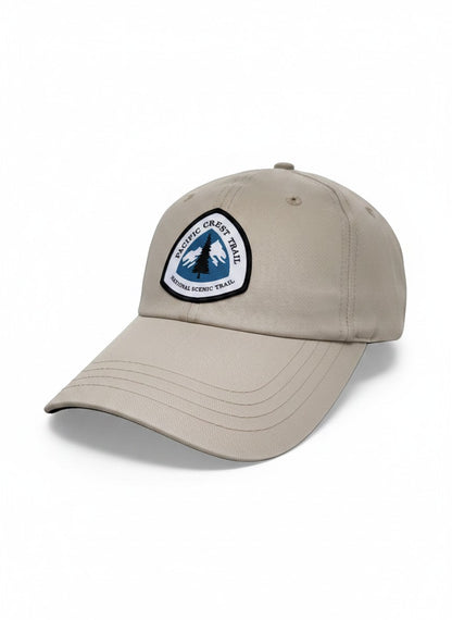 Moove Headwear tan cotton baseball cap with embroidered Pacific Crest Trail logo, adjustable strap, and breathable fabric.
