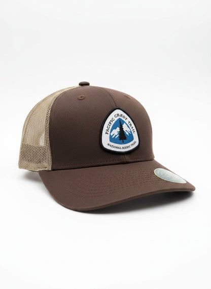 Moove Headwear brown trucker hat with Pacific Crest Trail patch and tan mesh back. Adjustable snapback closure.