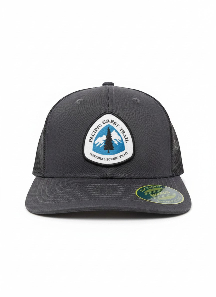 Moove Headwear dark grey trucker hat with Pacific Crest Trail patch featuring a tree and mountains.