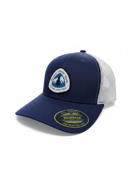 Moove Headwear navy blue trucker hat with white mesh back and Pacific Crest Trail patch. Adjustable snapback closure.