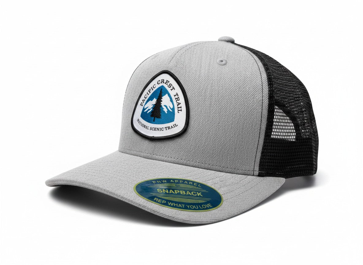 Moove Headwear grey and black trucker hat with Pacific Crest Trail patch, adjustable snapback closure.