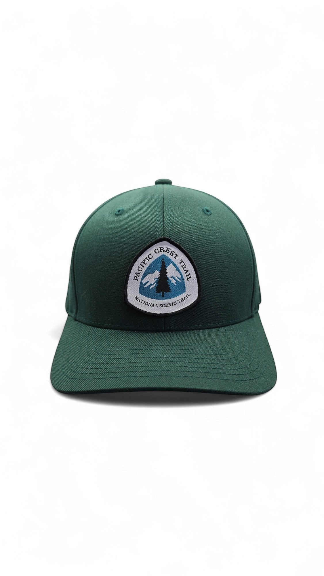 Moove Headwear dark green baseball cap with Pacific Crest Trail patch, featuring a mountain and tree graphic.