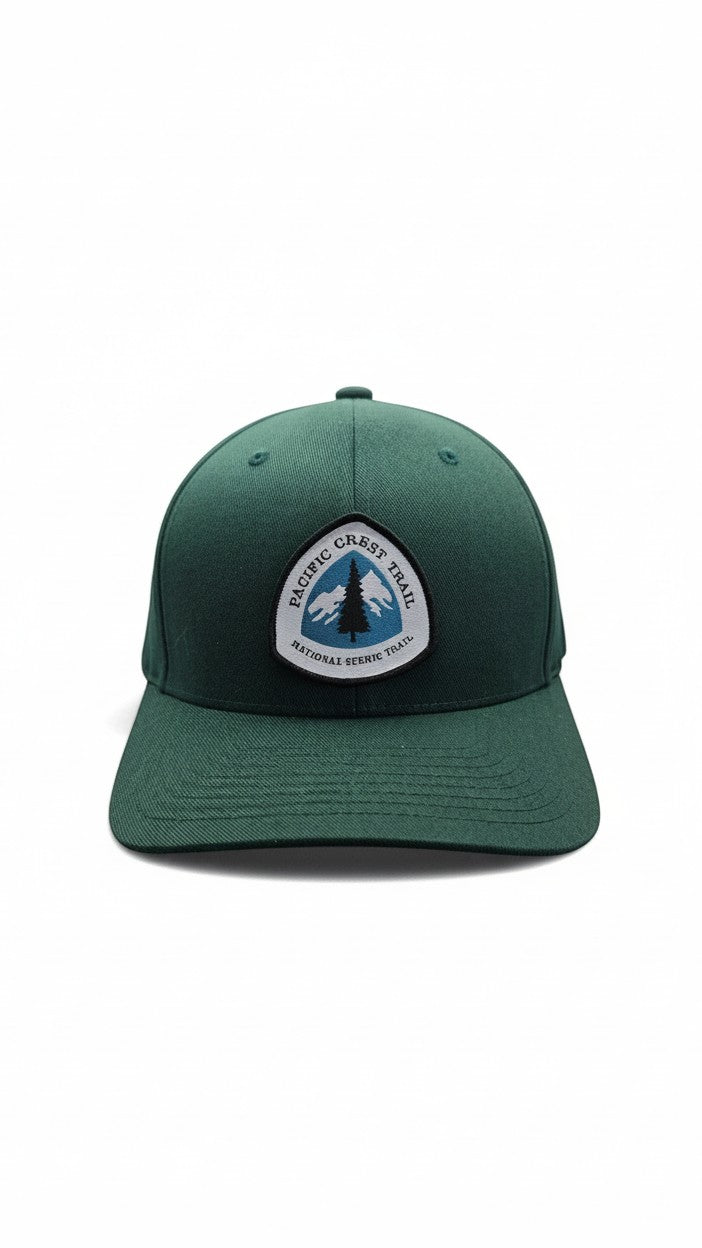 Moove Headwear dark green baseball cap with Pacific Crest Trail patch featuring mountains and a tree.