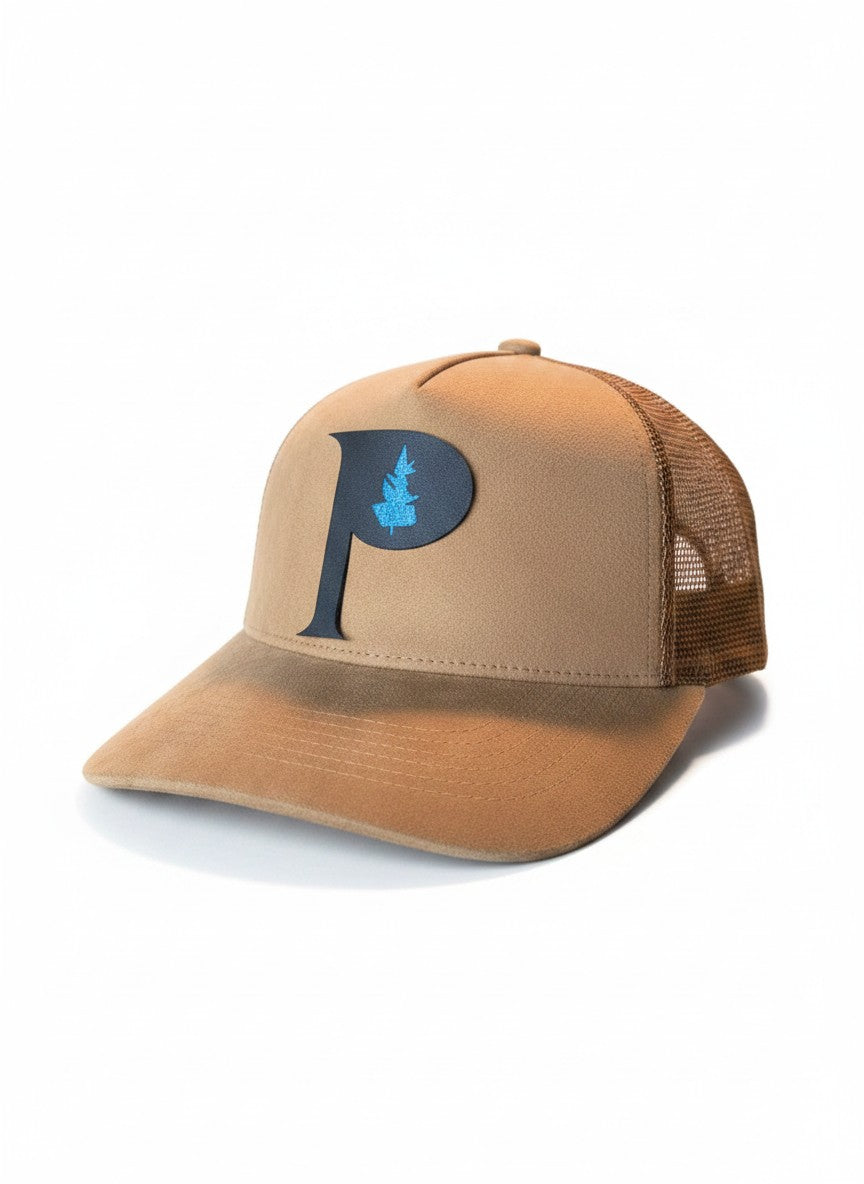 Moove Headwear tan suede trucker hat with a dark blue P logo and blue tree detail, mesh back, adjustable snapback.