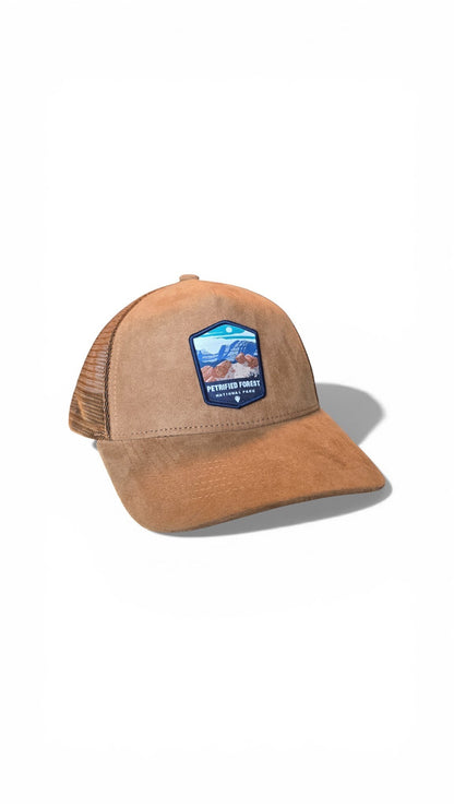 Moove Headwear tan suede trucker hat with Petrified Forest National Park embroidered patch and mesh back.