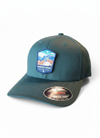 Moove Headwear Petrified Forest National Park patch on a teal fitted Flexfit hat with a mid-profile crown.
