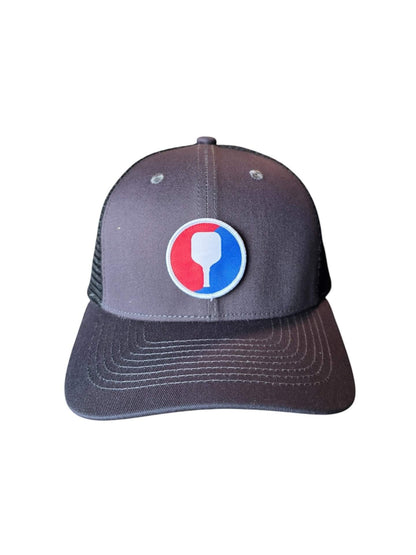 Moove Headwear grey trucker hat with pickleball paddle patch and mesh back. Adjustable snapback closure.