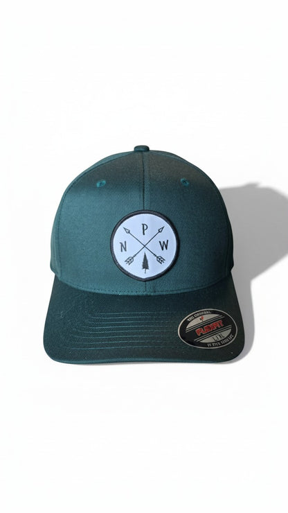 Moove Headwear dark teal Flexfit hat with embroidered PNW Arrows patch and a tree graphic.