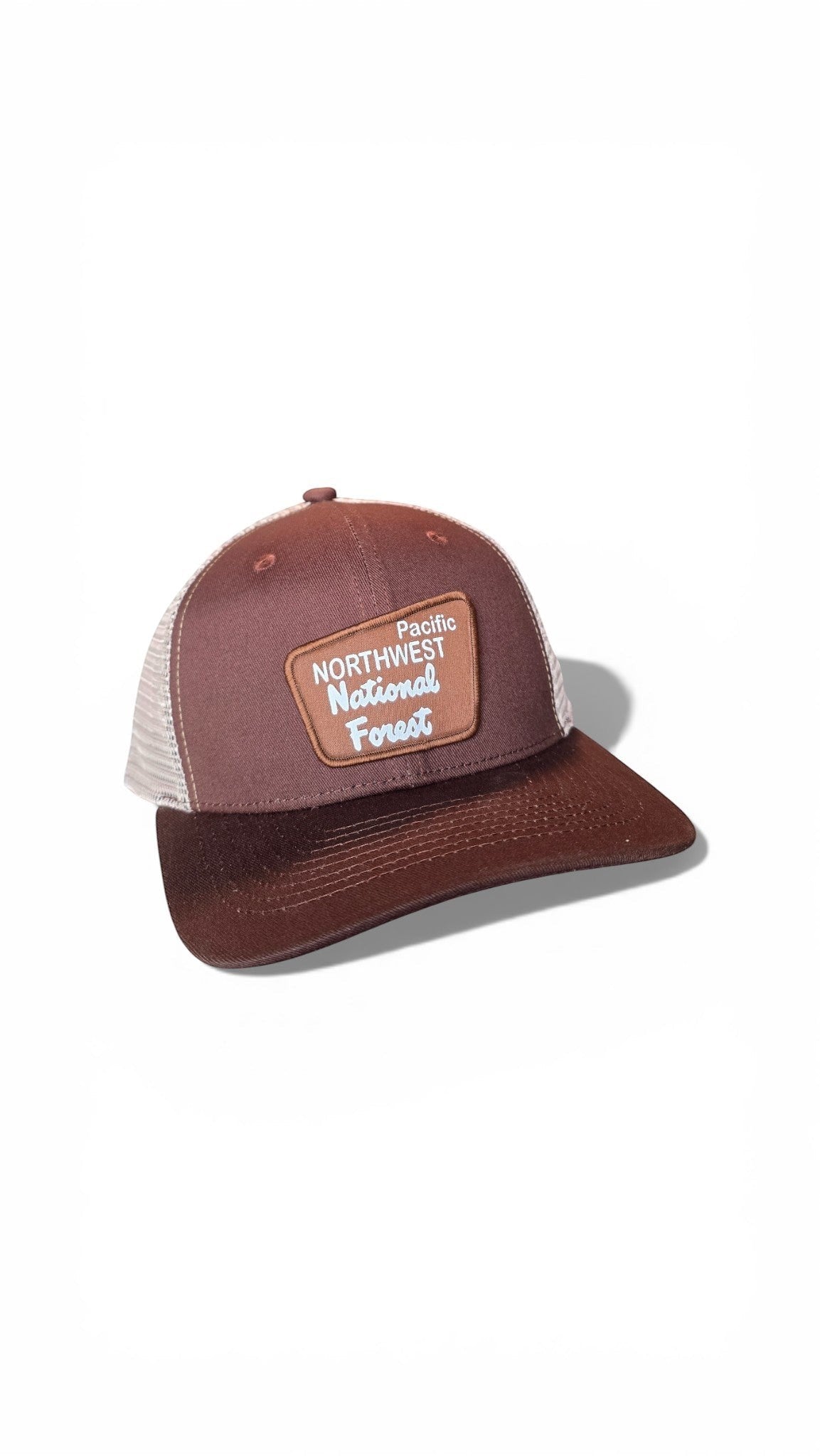 Moove Headwear brown trucker hat with mesh back and Pacific Northwest National Forest patch. Adjustable snapback for hiking and camping.