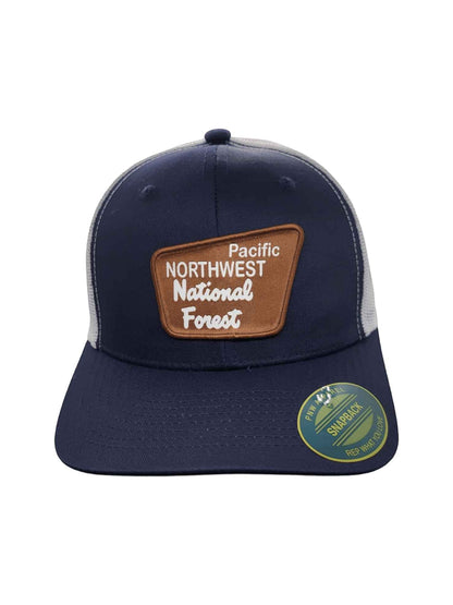 Moove Headwear navy blue trucker hat with mesh back and a brown patch that says Pacific Northwest National Forest.