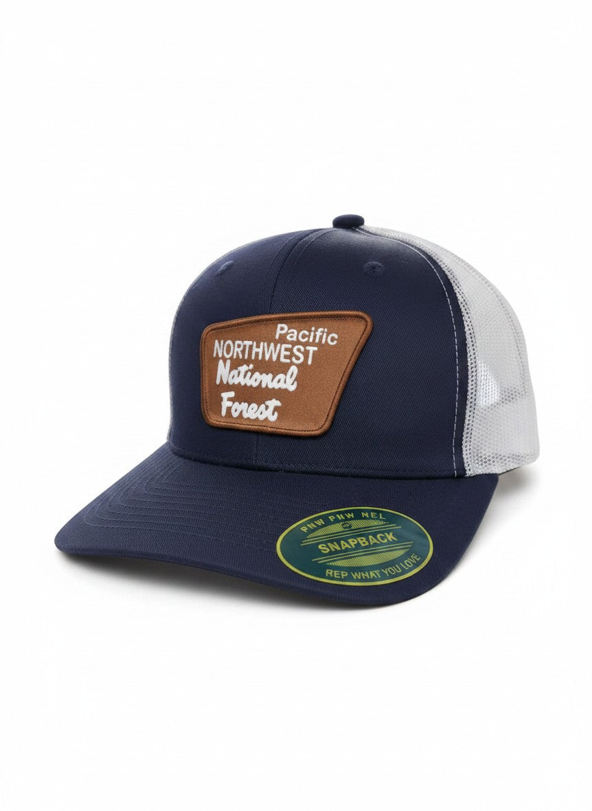 Moove Headwear navy blue trucker hat with mesh back and a brown patch that says Pacific Northwest National Forest.