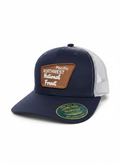 Moove Headwear navy blue trucker hat with mesh back and a brown patch that says Pacific Northwest National Forest.