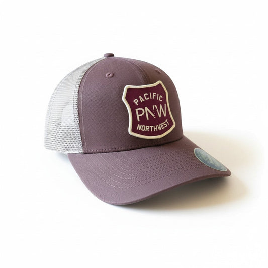 Moove Headwear Pacific Northwest trucker hat in plum with a mesh back and a shield-shaped patch with PNW graphic.