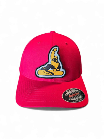 Moove Headwear red fitted cap with a black and gold snowboarder patch. Mid-profile structured crown, Flexfit design.