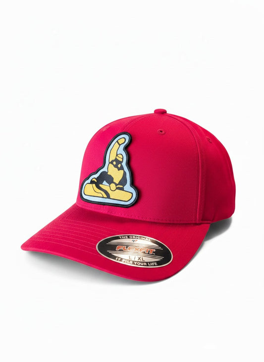 Moove Headwear red fitted cap with a black and gold snowboarder patch. Mid-profile structured crown, Flexfit design.