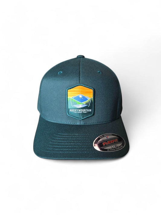 Moove Headwear Rocky Mountain National Park Flexfit baseball cap in dark teal with embroidered mountain landscape patch. Breathable fabric.