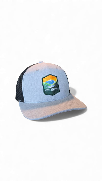 Moove Headwear light blue trucker hat with black mesh back and Rocky Mountain National Park logo patch.