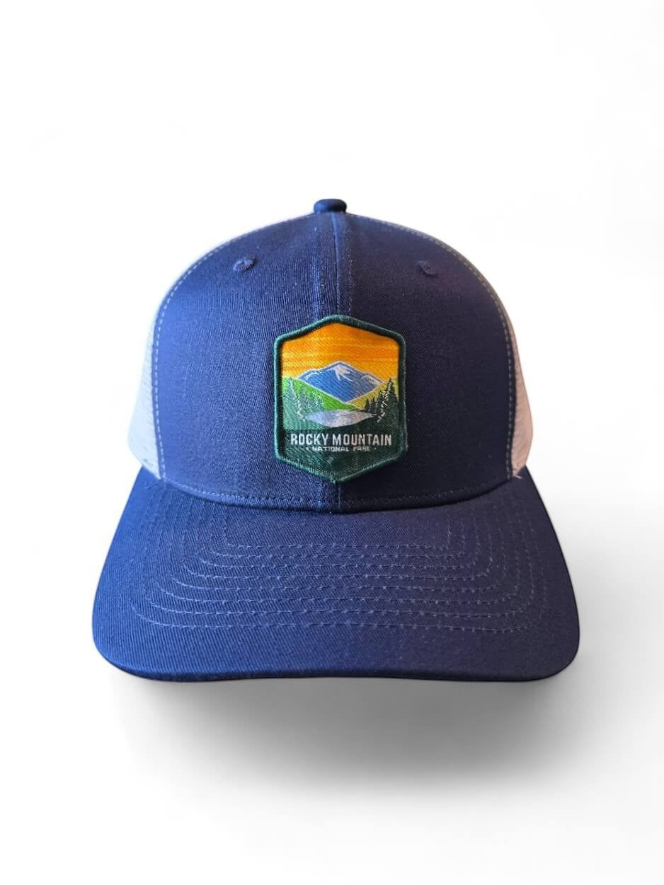 Moove Headwear navy blue trucker hat with Rocky Mountain National Park embroidered patch and white mesh back. Adjustable snapback.