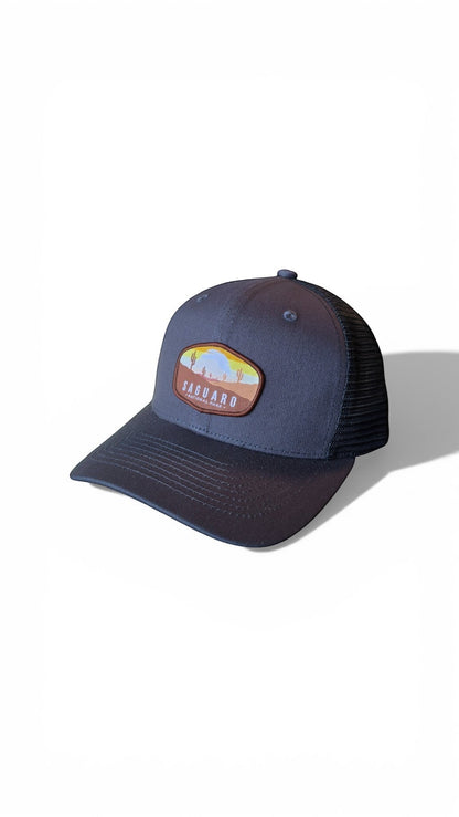 Moove Headwear navy blue trucker hat with Saguaro National Park embroidered patch and mesh back.