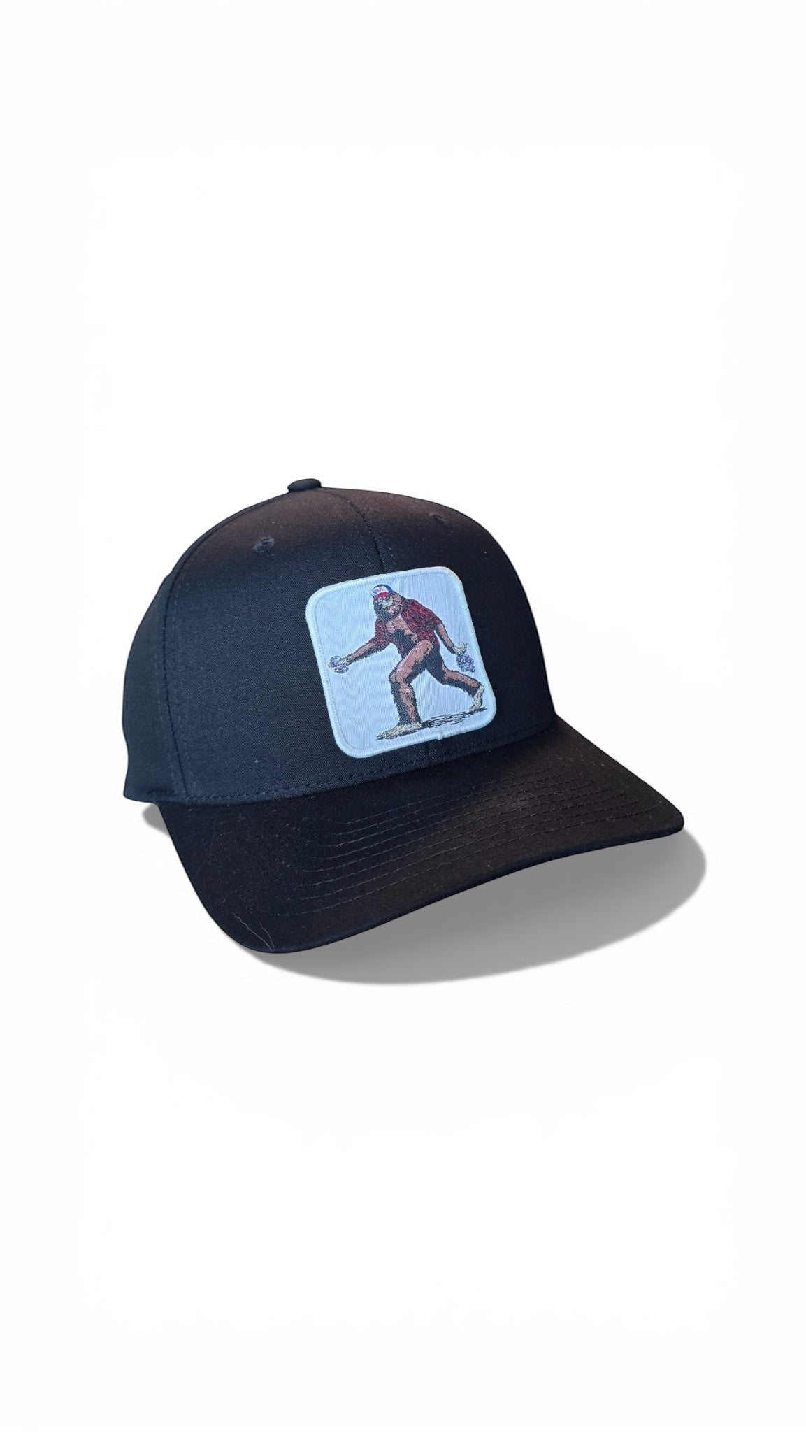 Moove Headwear black baseball cap with embroidered Sasquatch graphic patch on front. Fitted dad hat style.