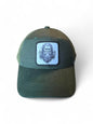 Moove Headwear dark green dad hat with a woven patch featuring a sketch of Bigfoot and trees.